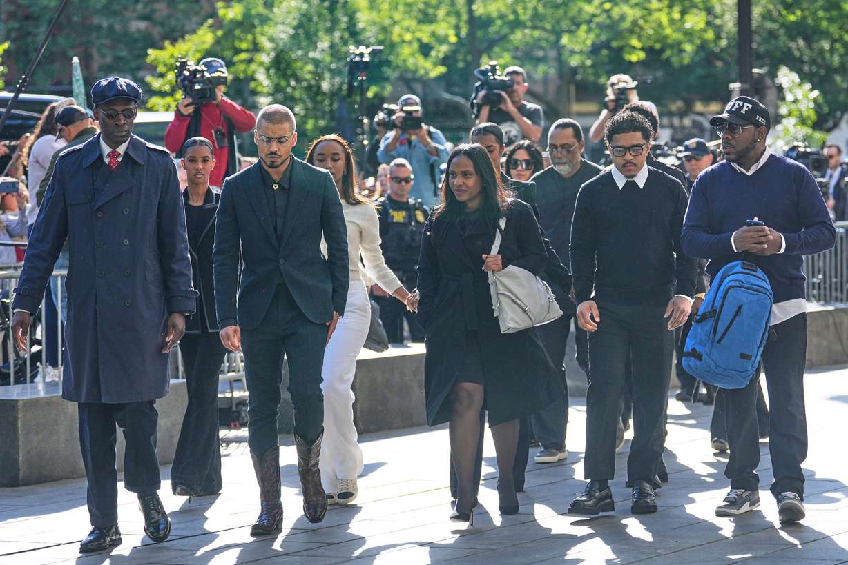 Family and supporters of Sean "Diddy" Combs, including his sons Quincy Brown, third from left, and Justin Combs, second from right, arrive to the courthouse in New York, Monday.