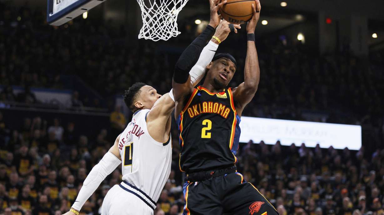 Oklahoma City Thunder guard Shai Gilgeous-Alexander (2) comes down with a rebound in front of Denver Nuggets' Russell Westbrook, left, in the first half of Game 1 of an NBA basketball second-round playoff series Monday, May 5, 2025, in Oklahoma City.