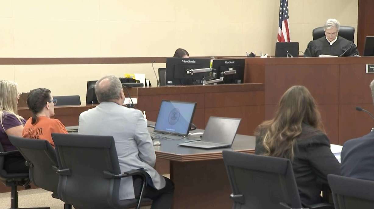 Nichole Scott, right, stepmother of a 12-year-old Gavin Peterson, listens to a judge Monday as she is ordered to spend at least 20 years and up to life in prison after pleading guilty to Gavin's murder.