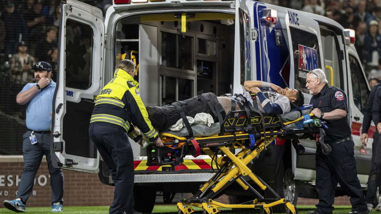 New York Yankees' Oswaldo Cabrera is taken from the field by ambulance after injuring his leg while scoring a run during the ninth inning of a baseball game against the Seattle Mariners, Monday, May 12, 2025, in Seattle.