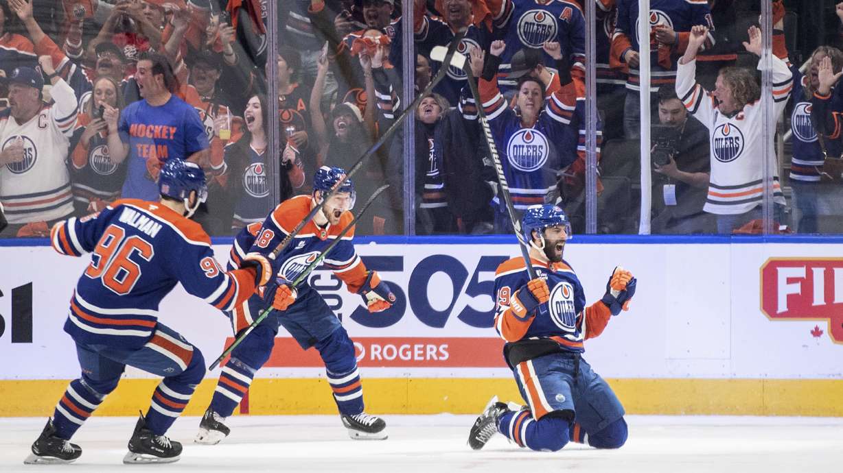 Edmonton Oilers' Adam Henrique (19), Jake Walman (96) and Zach Hyman (18) celebrate after a goal against the Vegas Golden Knights during the first period of Game 4 of a second-round NHL hockey playoff series in Edmonton, Alberta, Monday, May 12, 2025.