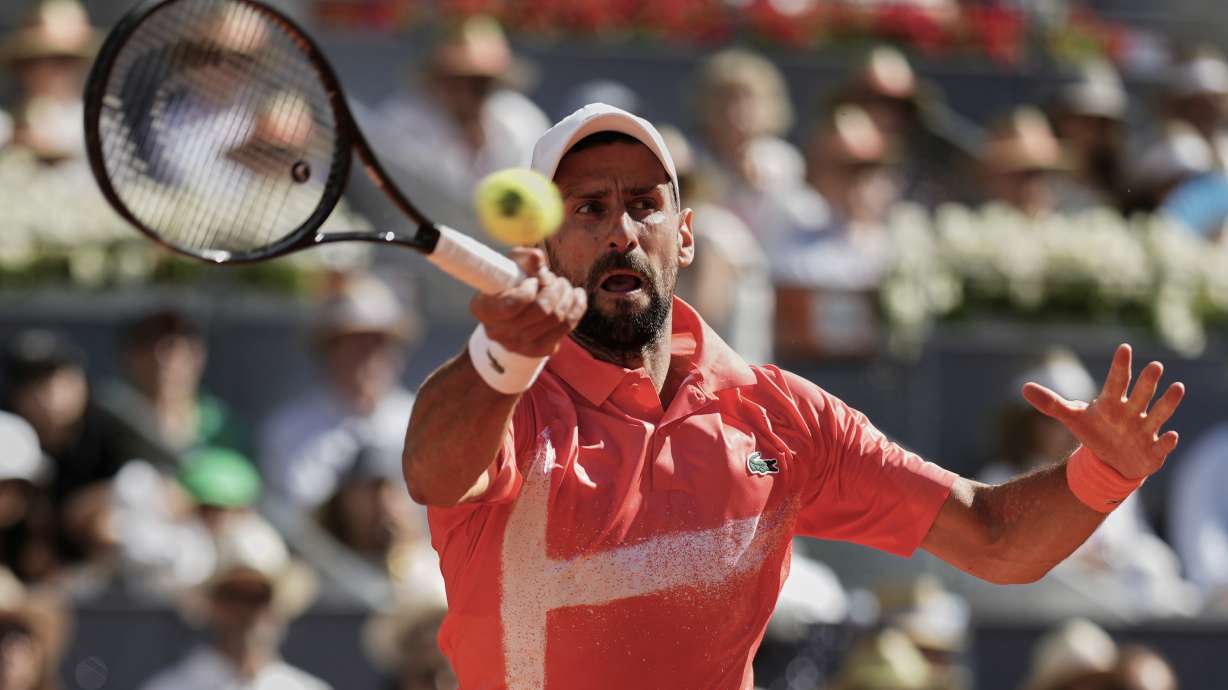 Novak Djokovic of Serbia returns the ball against Matteo Arnaldi of Italy during the Madrid Open tennis tournament in Madrid, Spain, Saturday, April 26, 2025.
