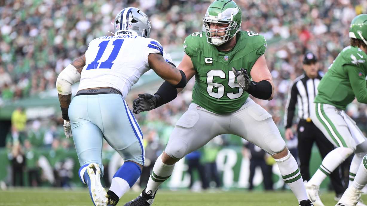 FILE - Philadelphia Eagles offensive tackle Lane Johnson (65) in action against Dallas Cowboys linebacker Micah Parsons (11) during the second half of an NFL football game, Dec. 29, 2024, in Philadelphia.