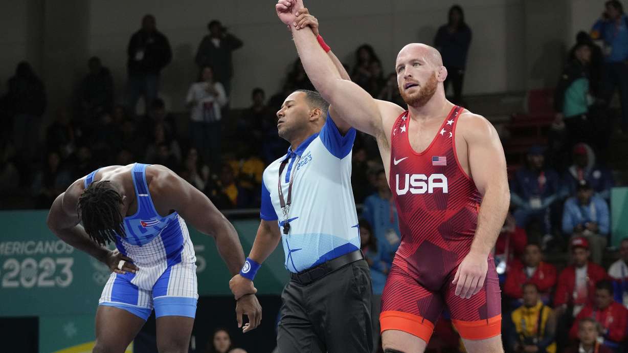 FILE - United States' Kyle Snyder, right, celebrates after winning gold against Cuba's Arturo Silot, left, during the men's 97kg wrestling freestyle final bout at the Pan American Games Santiago, Chile, Nov. 1, 2023.