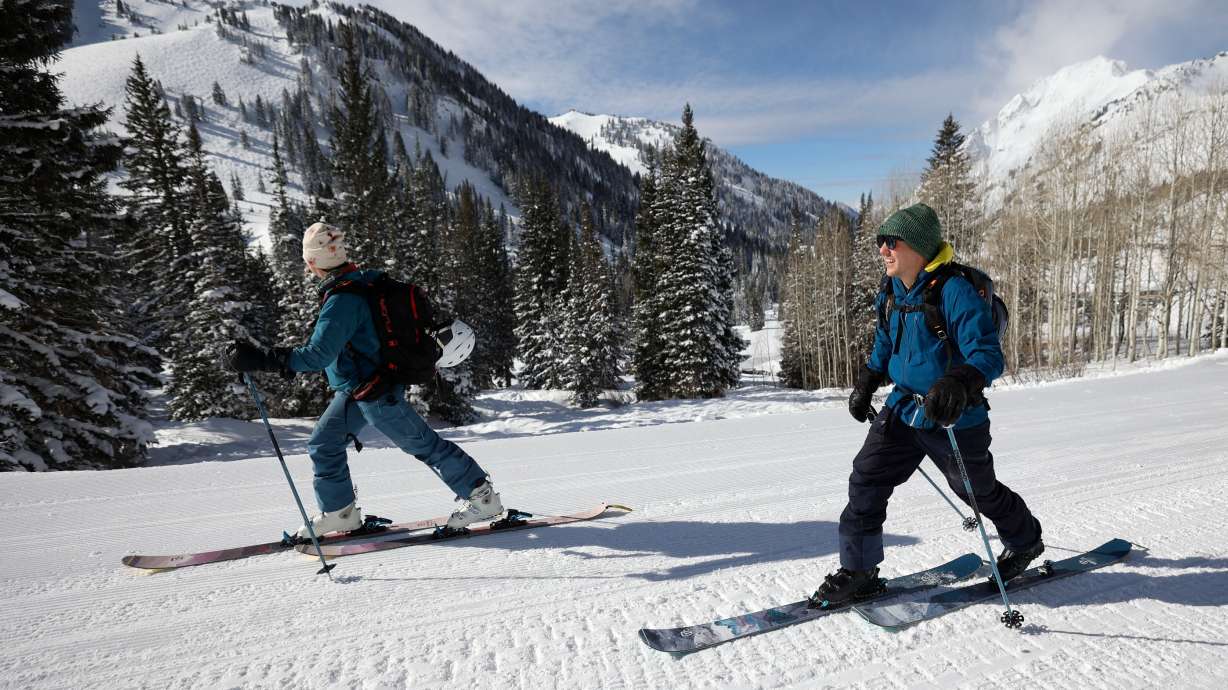 Ashley Marten and Alastair Moody ski up Little Cottonwood Canyon on Feb. 12. Ski resorts in the Rocky Mountain states accounted for nearly 43% of all skier days nationwide this past season.