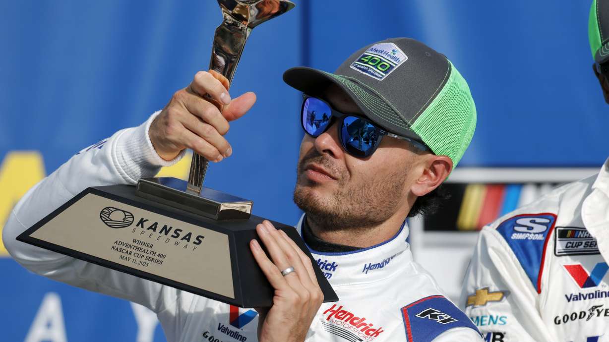 Kyle Larson celebrates in Victory Lane after winning a NASCAR Cup Series auto race at Kansas Speedway in Kansas City, Kan., Sunday, May 11, 2025.