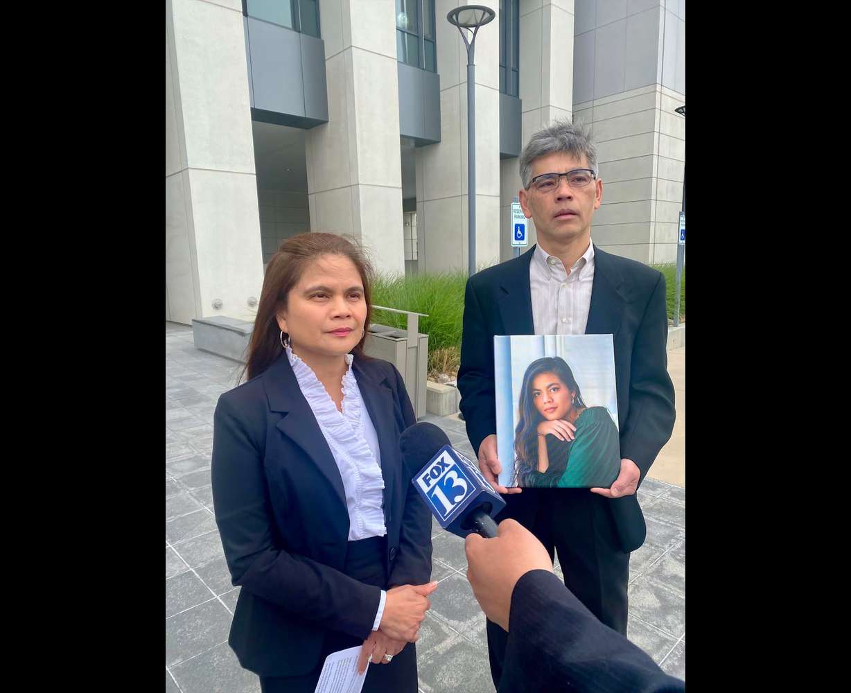 Rose and Keith Nguyen hold a picture of their daughter, Rena, outside 4th District Court in Provo on Tuesday. Rena Nguyen's boyfriend, Caleb Aidan Rees, is charged with manslaughter and accused of abusing Rena during a tumultuous relationship that prosecutors say drove her to suicide in 2021.
