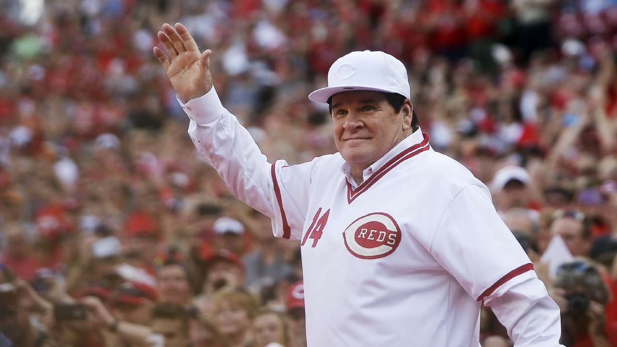 FILE - In this June 24, 2016, file photo, former Cincinnati Red Pete Rose waves to the crowd as he is introduced on the field during a ceremony to honor the 1976 World Series champions team, before the Reds' baseball game against the San Diego Padres in Cincinnati. \