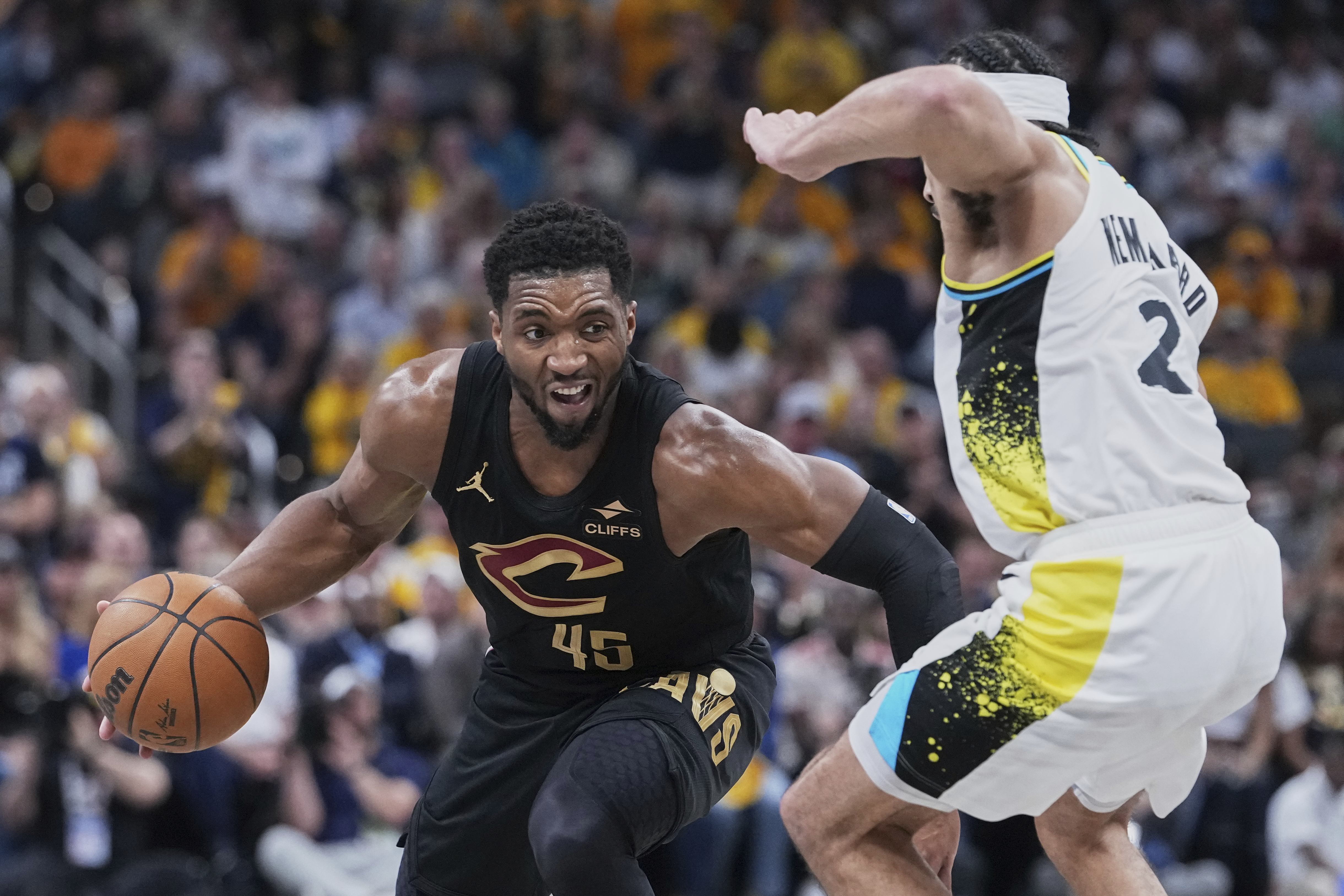 Cleveland Cavaliers guard Donovan Mitchell (45) drives to the basket against Indiana Pacers guard Andrew Nembhard (2) in the first half of Game 4 in the Eastern Conference semifinals of the NBA basketball playoffs in Indianapolis, Sunday, May 11, 2025.