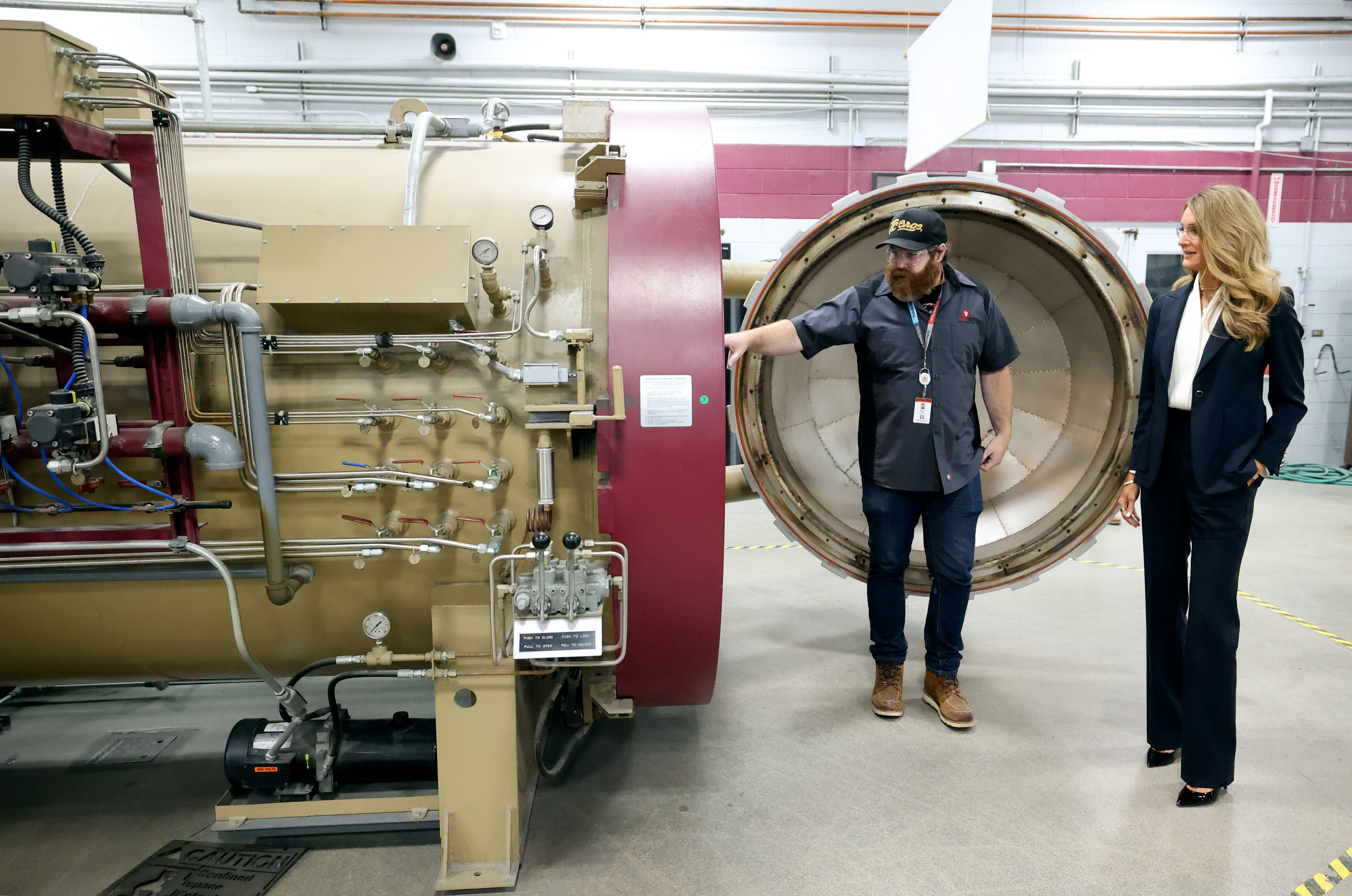 Joshua Putnam, Davis Technical College composite material technology lead instructor, shows Kelly Loeffler, the 28th administrator of the U.S. Small Business Administration, an autoclave used to vacuum and compress aerospace parts at Davis Technical College in Kaysville on Tuesday.