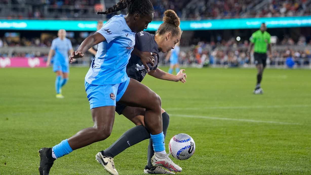 FILE - Houston Dash forward Michelle Alozie, left and Bay FC defender Savy King compete for possession of the ball during the first half of an NWSL soccer match, March 30, 2024, in San Jose, Calif.