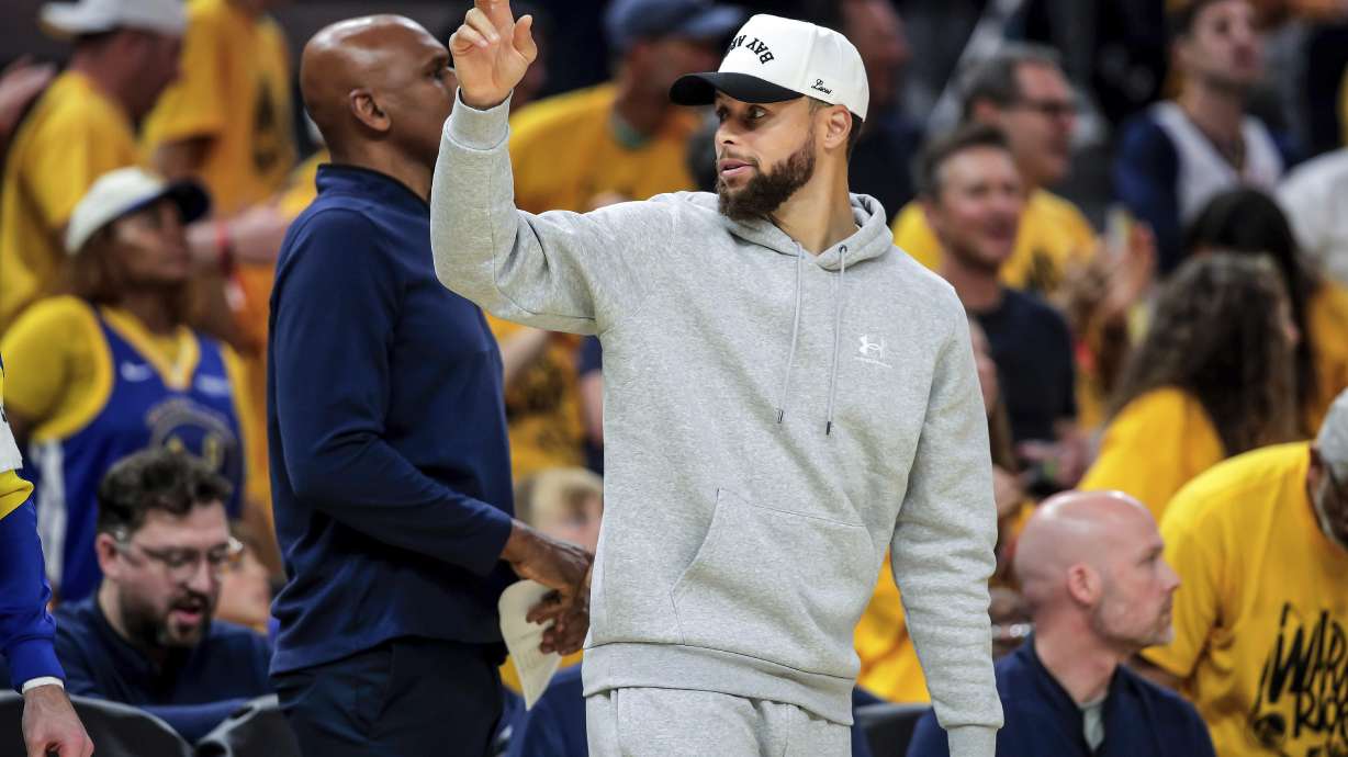 Golden State Warriors' Stephen Curry, center right, gestures to teammate Draymond Green that he is subbing in the first half of Game 3 of an NBA basketball second-round playoff series against the Minnesota Timberwolves in San Francisco, Saturday, May 10, 2025.