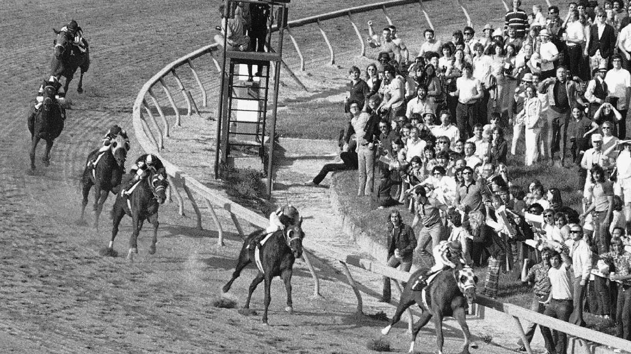 FILE - Secretariat, right, leads the field coming out of the final turn as he heads for the finish line to wn in the 98th Preakness Stakes Saturday, May 19, 1973 at at Pimlico Race Course in Baltimore.