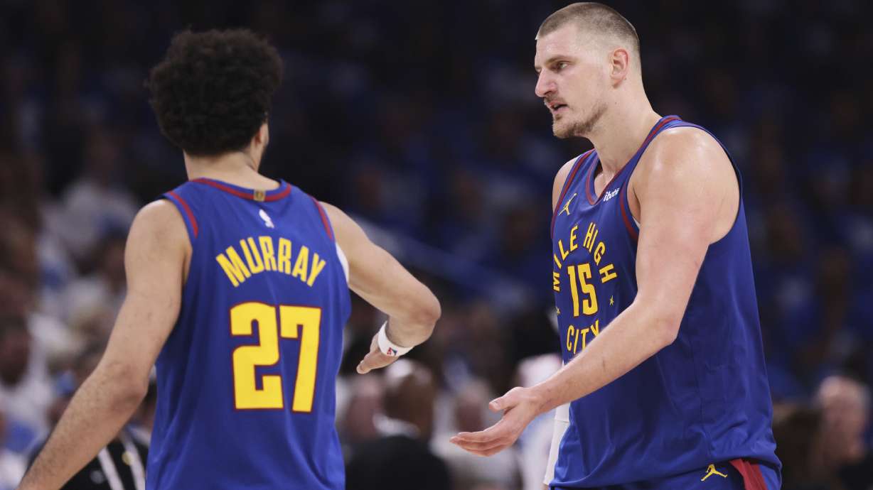 Denver Nuggets' Jamal Murray (27) and Nikola Jokic (15) celebrate in the second half of Game 5 of an NBA basketball second-round playoff series against the Oklahoma City Thunder Tuesday, May 13, 2025, in Oklahoma City.