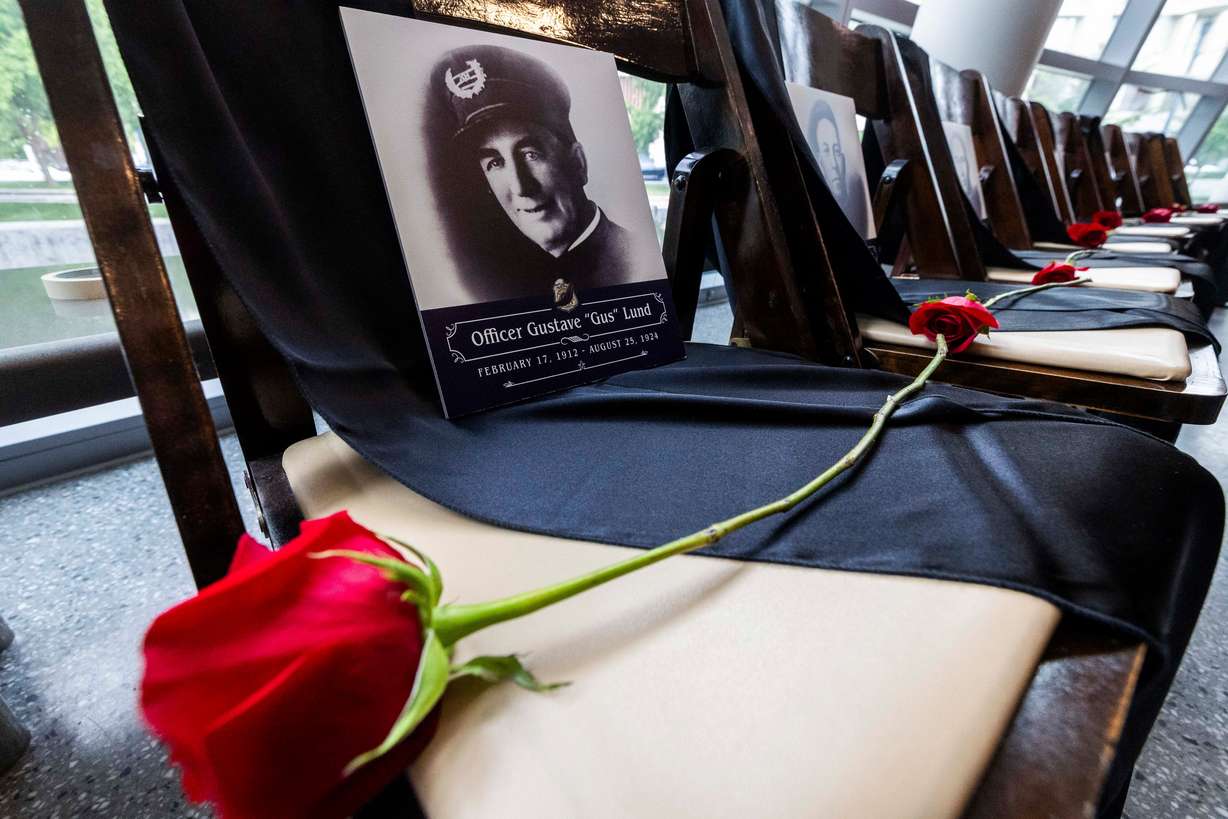 A rose lies on an empty chair with a photo of Officer Gustave “Gus” Lund at a ceremony to honor the lives of the 25 police officers who have died in the line of duty throughout the Salt Lake City Police Department’s history, at the Public Safety Building in Salt Lake City on Wednesday.