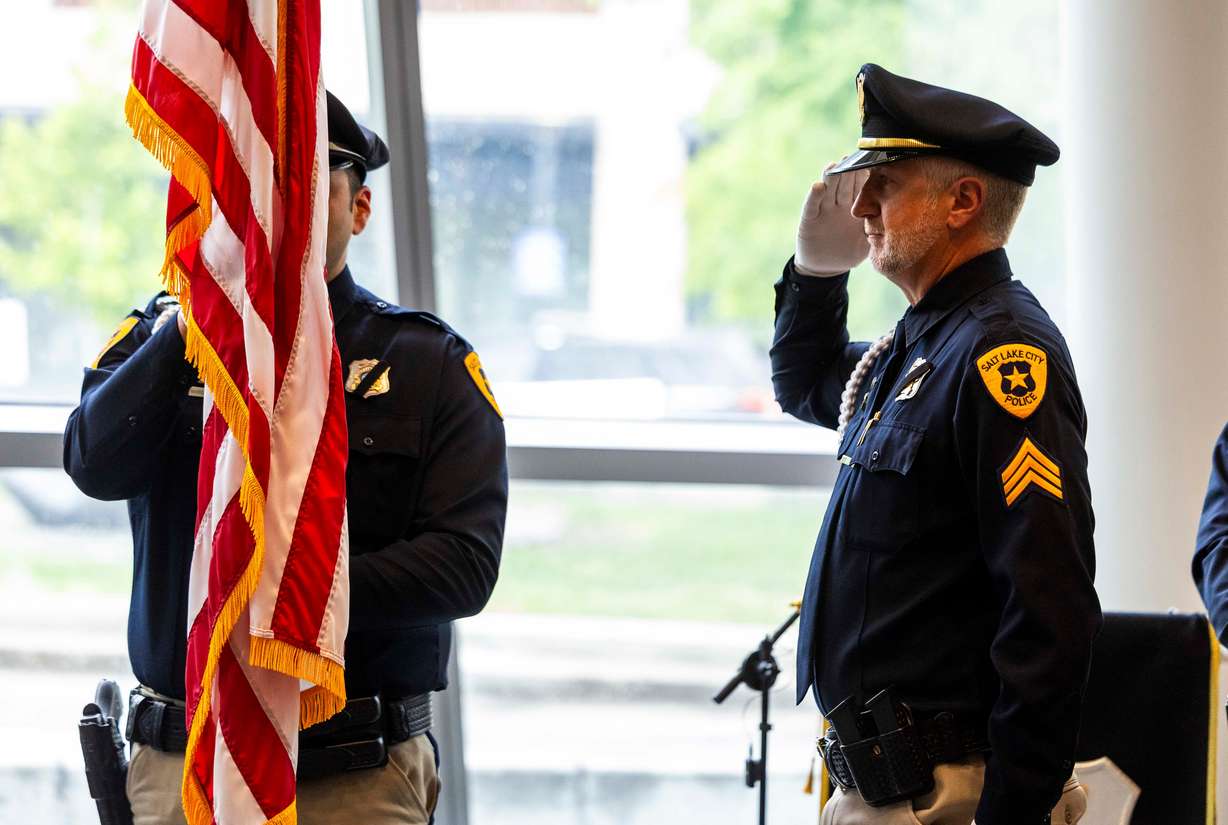 A member of the motors honor guard salutes the flag during the national anthem at a ceremony to honor the lives of the 25 police officers who have died in the line of duty throughout the Salt Lake City Police Department’s history, at the Public Safety Building in Salt Lake City on Wednesday.