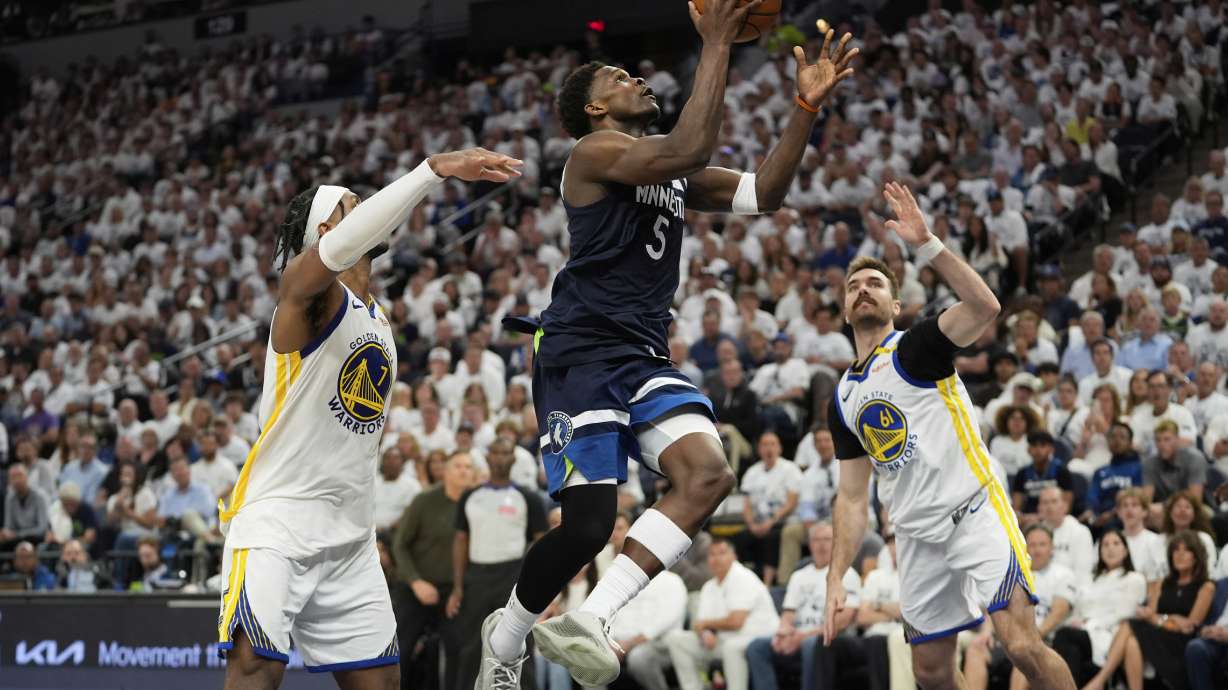 Minnesota Timberwolves guard Anthony Edwards (5) looks to shoot against Golden State Warriors' Pat Spencer, right, and Buddy Hield, left, during the second half of Game 5 of an NBA basketball second-round playoff series, Wednesday, May 14, 2025, in Minneapolis.