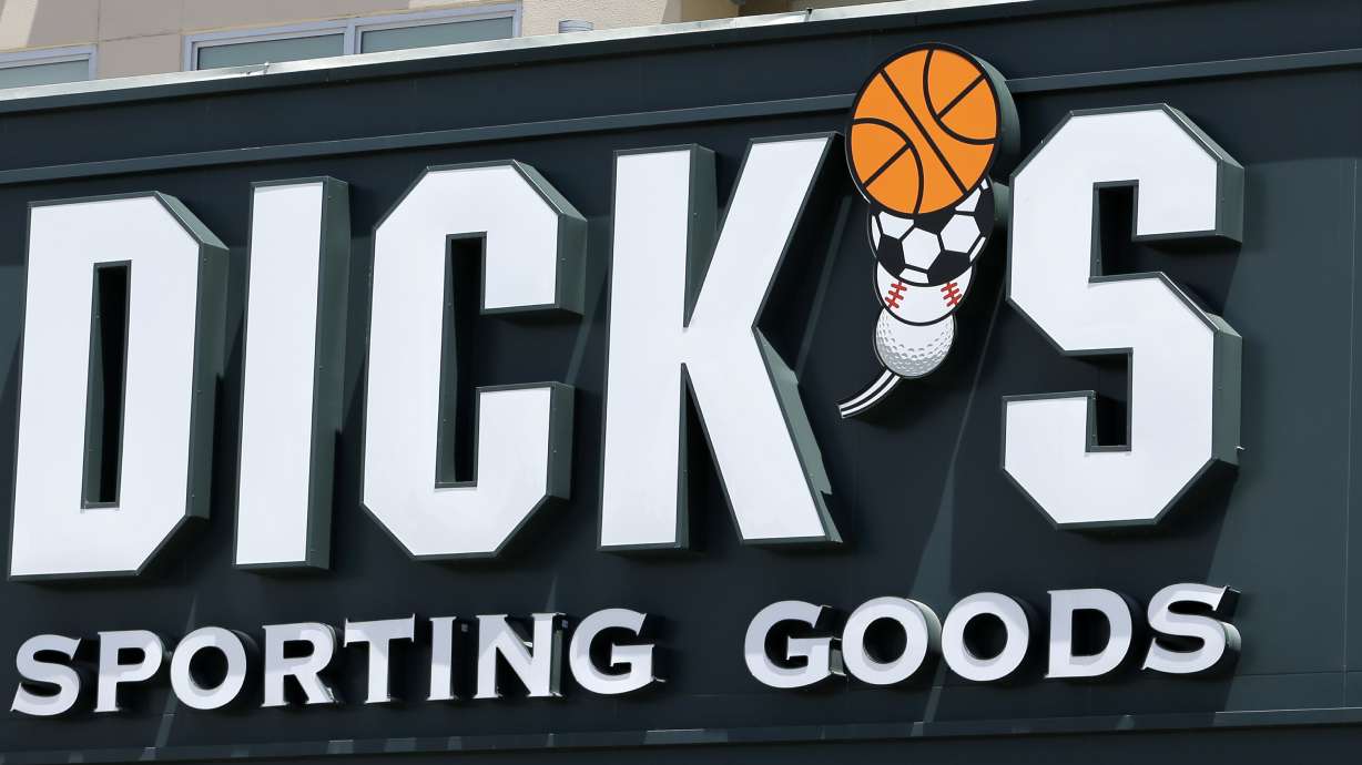 FILE -This photo taken Tuesday, Aug. 29, 2017, shows a Dick's Sporting Goods sign at a store in Miami.