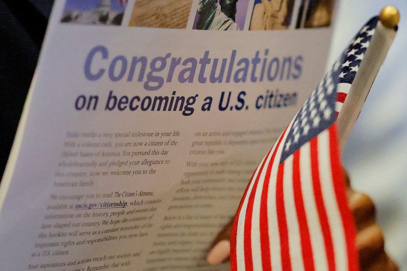 A new U.S. citizen holds a U.S. flag after a naturalization ceremony at the John F. Kennedy Presidential Library in Boston, Mass., March 11. The U.S. Supreme Court is poised on Thursday to consider President Donald Trump's attempt to broadly enforce his executive order to limit birthright citizenship.