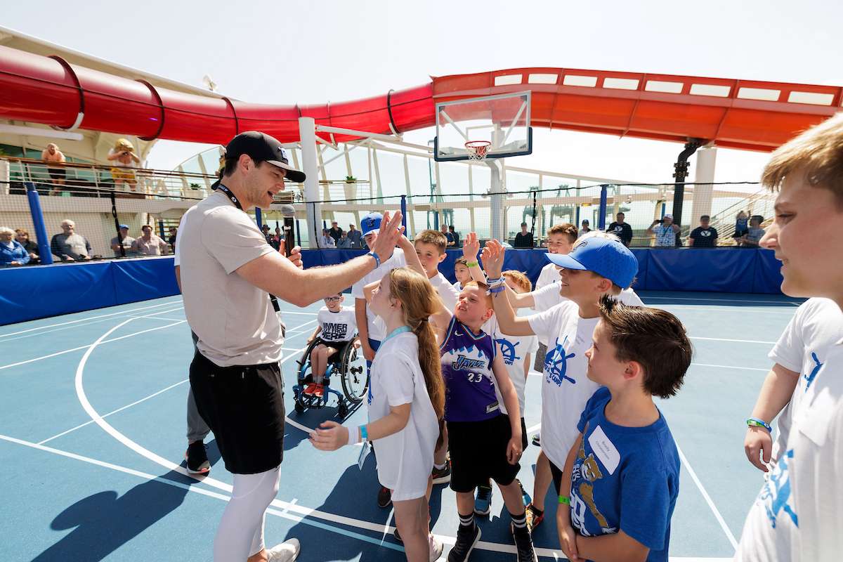 Former BYU basketball star Jimmer Fredette greets excited young fans aboard the BYU Cruise.