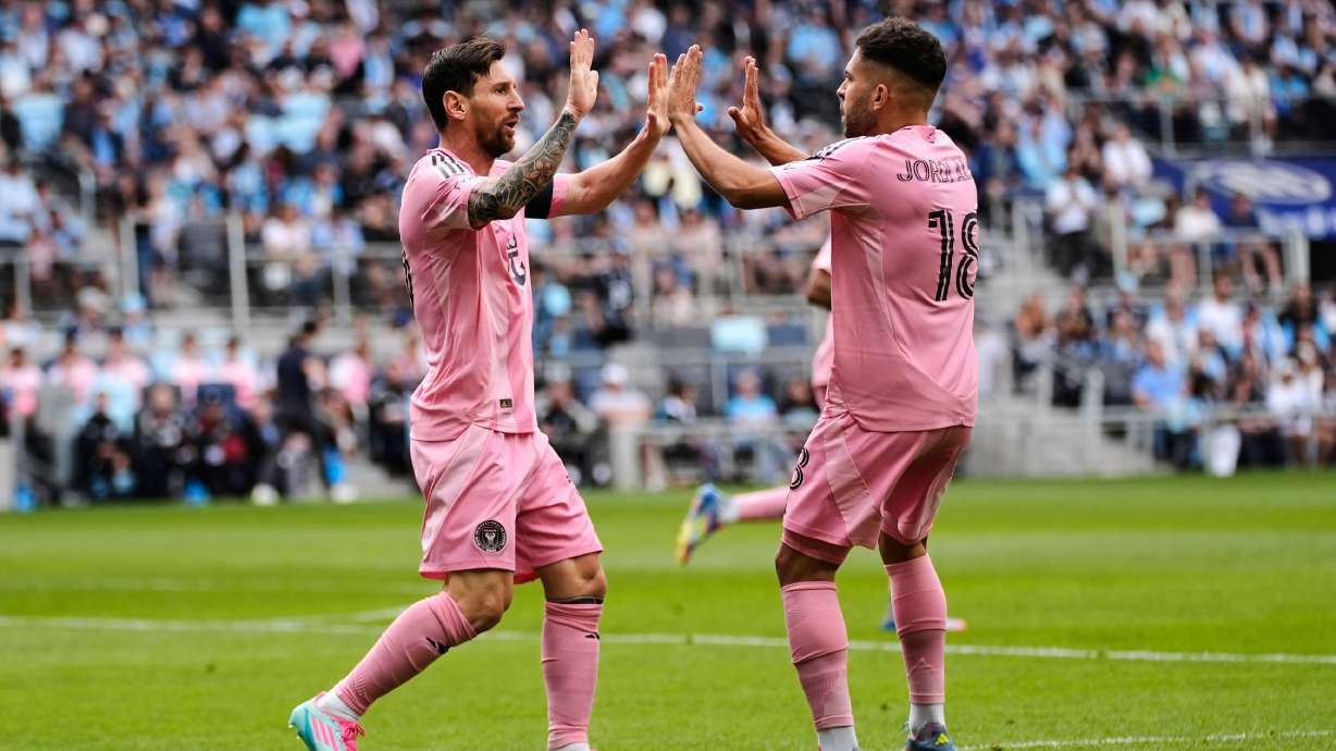 Inter Miami forward Lionel Messi, left, celebrates with defender Jordi Alba after scoring a goal during the second half of an MLS soccer match against Minnesota United, Saturday, May 10, 2025, in St. Paul, Minn.