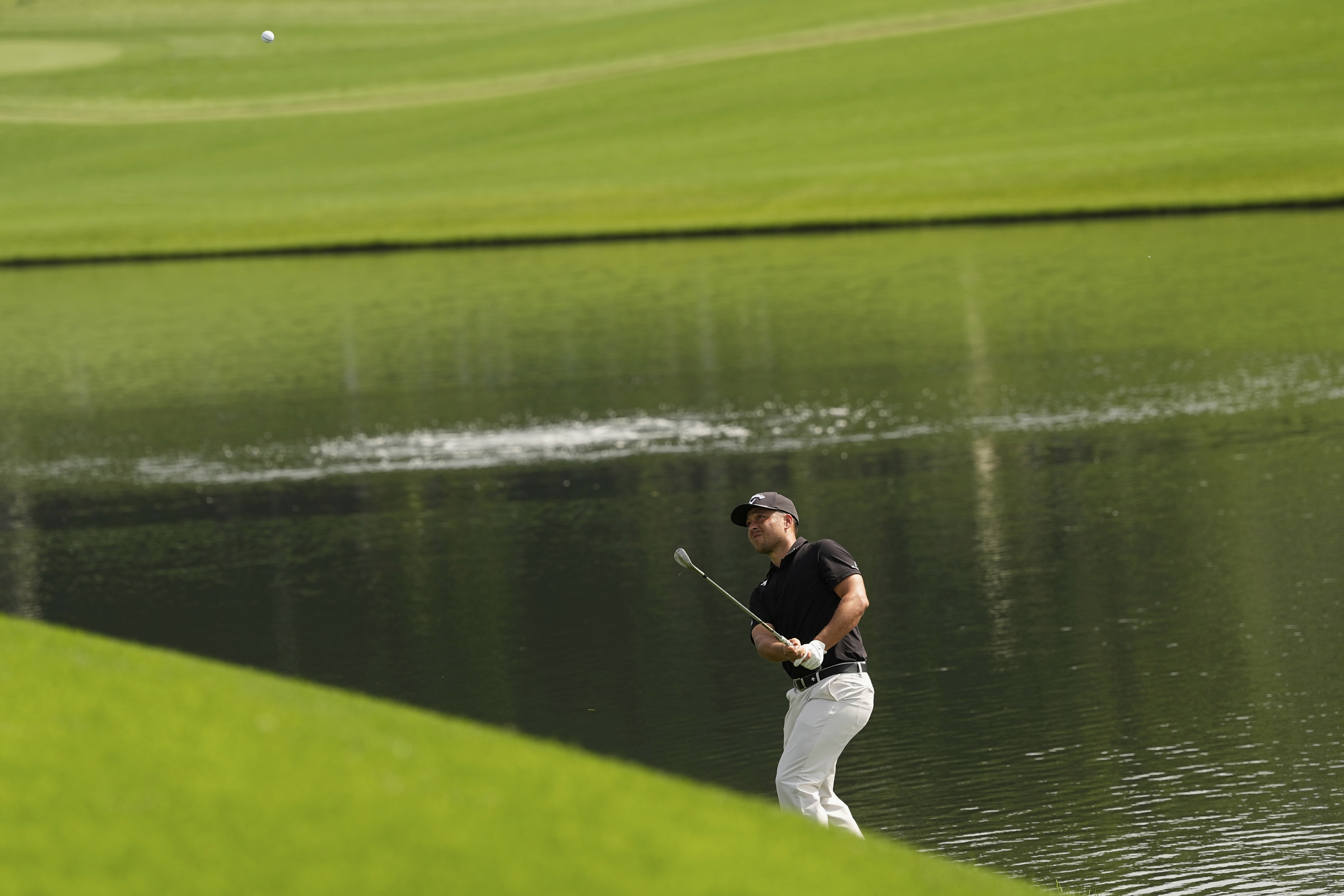 Xander Schauffele chips to the green on the 16th hole during the first round of the PGA Championship golf tournament at the Quail Hollow Club, Thursday, May 15, 2025, in Charlotte, N.C.