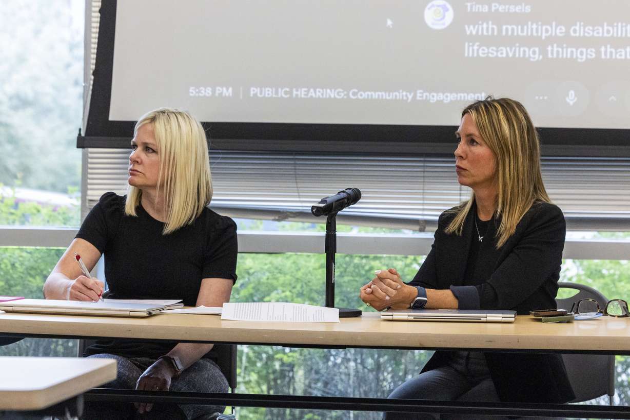 Michelle Smith, the director of the Office of Medicaid Eligibility Policy, left, and Jennifer Strohecker, the state Medicaid director, both listen to speakers from the public during a public hearing on a proposal to impose work reporting requirements on Medicaid recipients at the Multi-Agency State Office Building in Salt Lake City on Wednesday.
