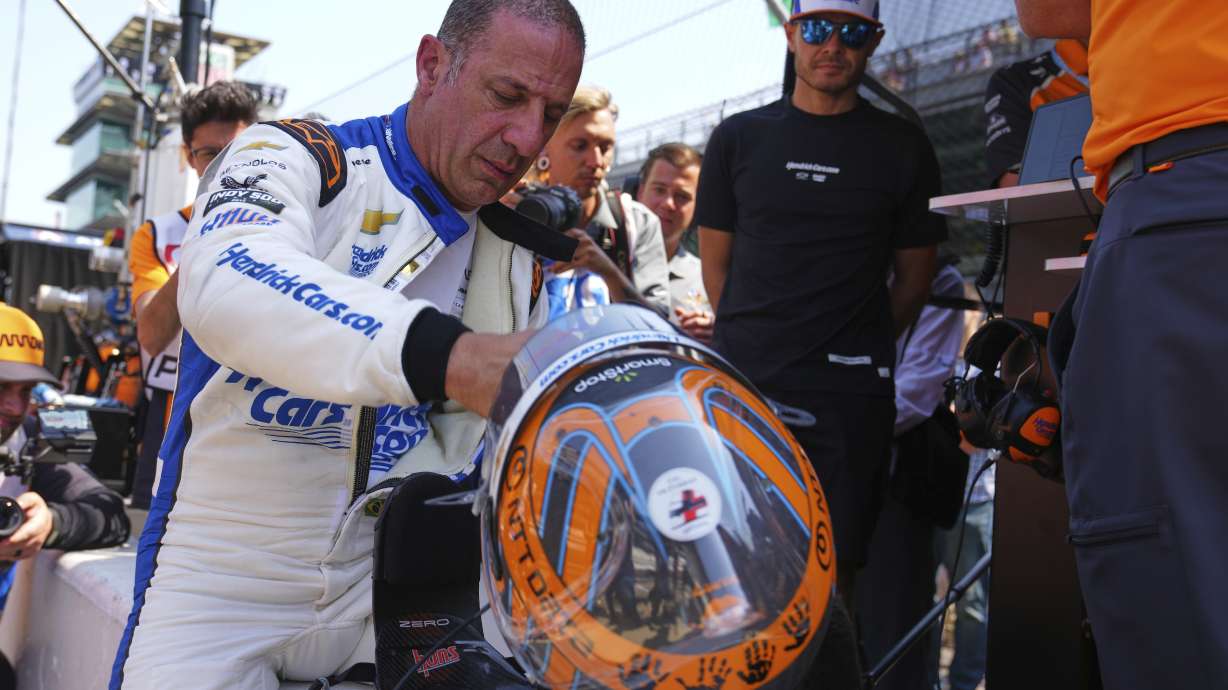 Kyle Larson, right, looks on as Tony Kanaan, of Brazil, removes stows his helmet after driving during practice for the Indianapolis 500 auto race at Indianapolis Motor Speedway in Indianapolis, Thursday, May 15, 2025.