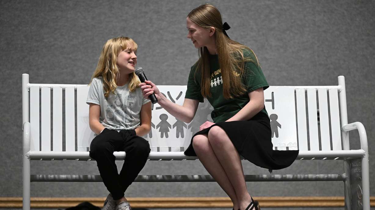 JATC student Ruby Sullivan talks with Monte Vista Elementary School student Eliza Westenskow on the "buddy bench" in South Jordan on Wednesday. The bench was built and donated to Monte Vista by the students of JATC.