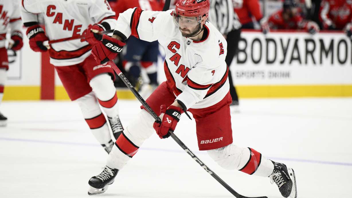 Carolina Hurricanes defenseman Shayne Gostisbehere (4) shoots the puck in the second period of Game 5 of a second-round NHL hockey playoff series against the Washington Capitals Thursday, May 15, 2025, in Washington.
