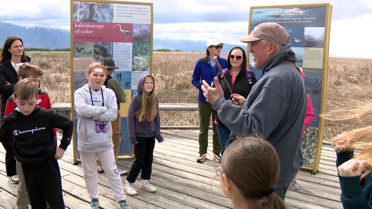 Brad Timothy talks to a group of fourth graders about migratory bird species that depend on the wetlands of the Great Salt Lake.