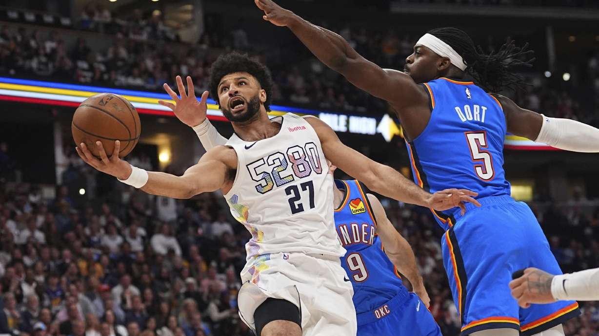 Denver Nuggets guard Jamal Murray, front left, drives to the basket as Oklahoma City Thunder guards Alex Caruso, back left, and Luguentz Dort defend in the first half of Game 6 in the Western Conference semifinals of the NBA basketball playoffs Thursday, May 15, 2025, in Denver.