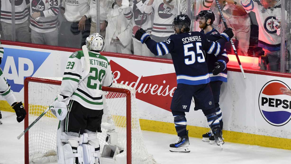 Winnipeg Jets' Mark Scheifele (55) celebrates his goal against Dallas Stars goaltender Jake Oettinger (29) with Kyle Connor (81) during second period NHL playoff hockey action in Winnipeg, Thursday, May 15, 2025.