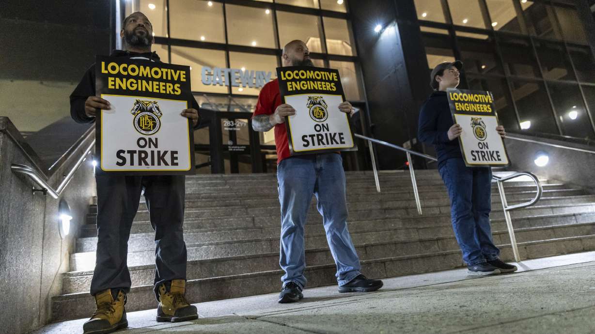 Union members from the Brotherhood of Locomotive Engineers and Trainmen form a picket line outside the NJ Transit Headquarters on Friday, in Newark, New Jersey.