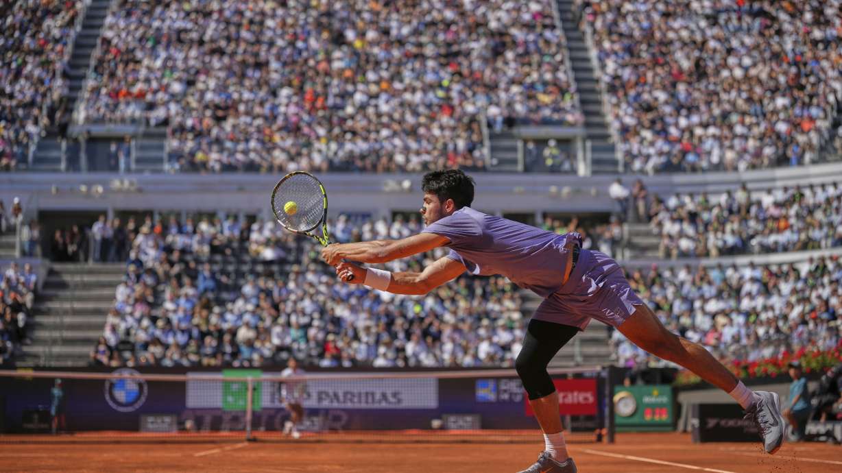 Spain's Carlos Alcaraz returns the ball to Italy's Lorenzo Musetti during their semifinal tennis match at the Italian Open, at the Foro Italico, in Rome, Friday, May 16, 2025.