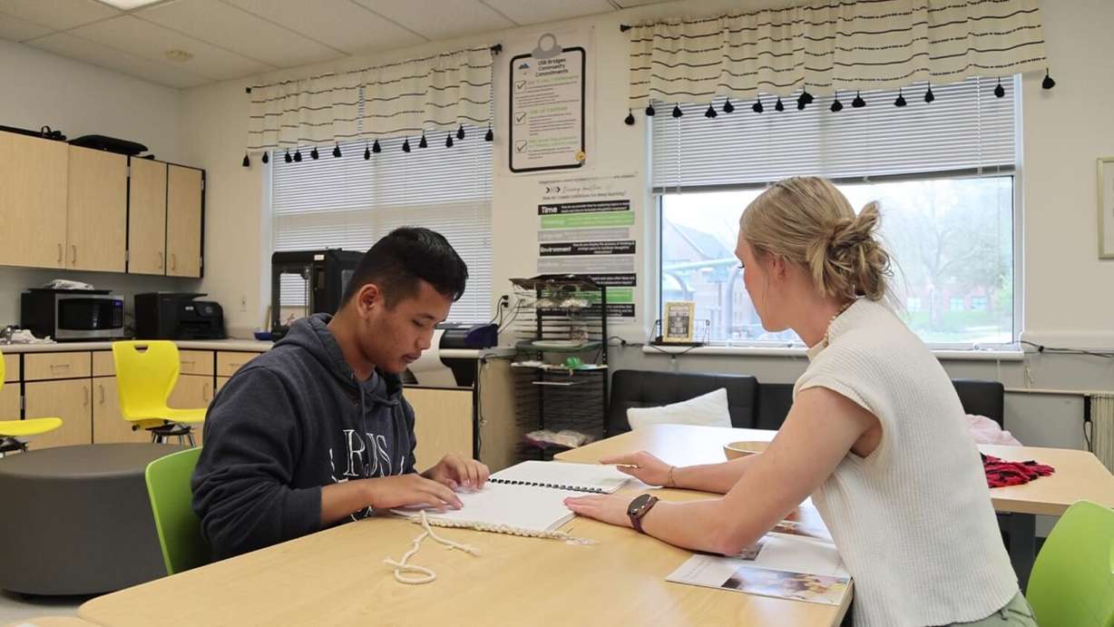 Sha Reh learning Braille with his new teacher.