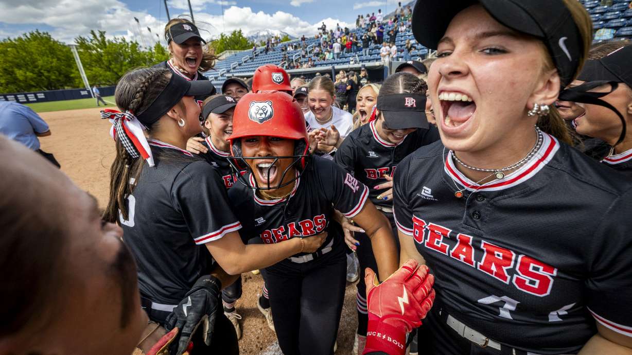 Bear River’s Marley Tisdol, center, celebrates with her teammates after her sacrifice fly allowed Aubree Fry to score and defeat Desert Hills in extra innings during the final game of the championship series in the 4A high school softball state tournament held at Miller Park in Provo on Friday, May 16, 2025. Bear River won the game 3-2 in eight innings, and the series 2-1.