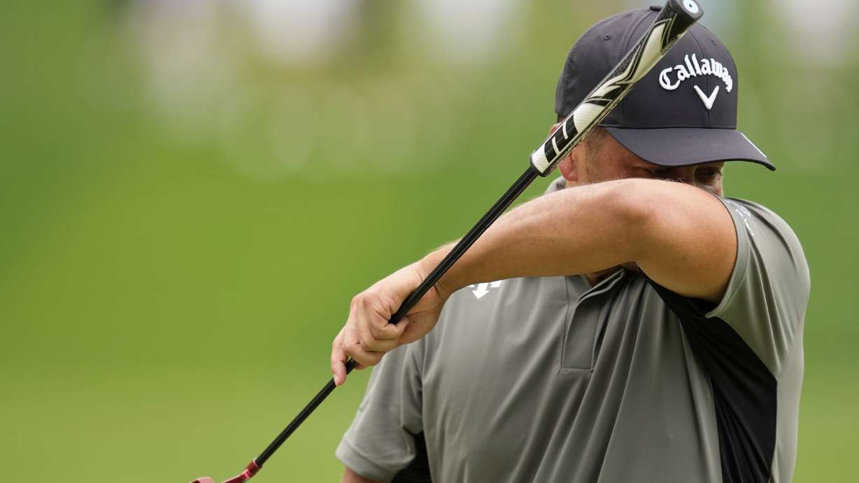 Xander Schauffele wipes his face on the sixth hole during the second round of the PGA Championship golf tournament at the Quail Hollow Club, Friday, May 16, 2025, in Charlotte, N.C.