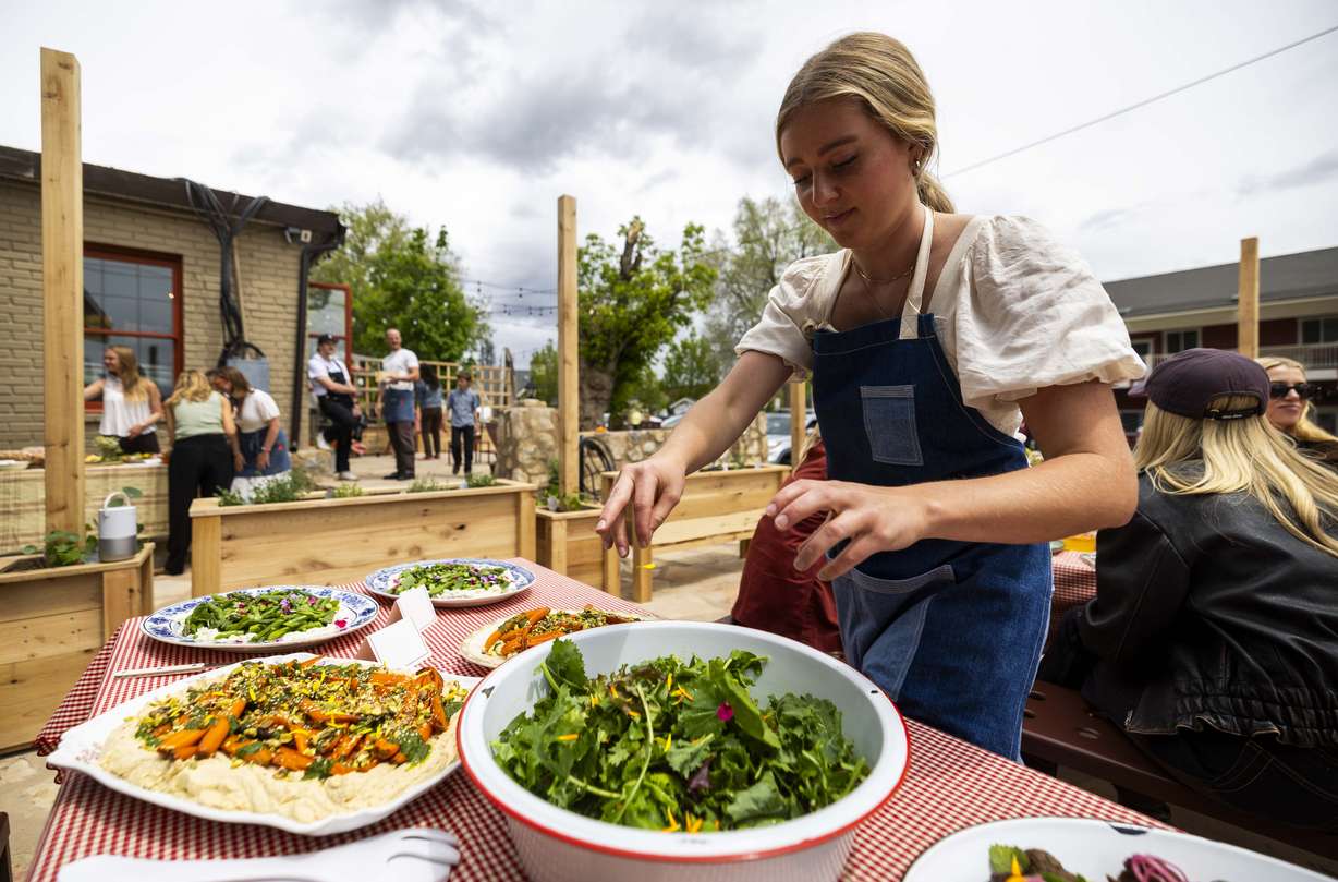 Ballerina Farm Store head chef Catherine Clark puts the finishing touches on samples of the store's food at the media day for Ballerina Farm’s new farm store in Midway on Friday.