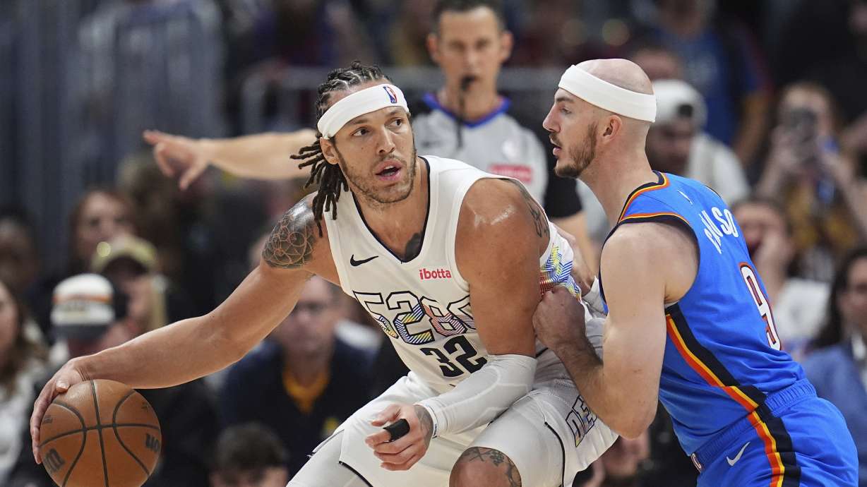 Denver Nuggets forward Aaron Gordon, left, looks to pass the ball as Oklahoma City Thunder guard Alex Caruso defends in the second half of Game 6 in the Western Conference semifinals of the NBA basketball playoffs Thursday, May 15, 2025, in Denver.