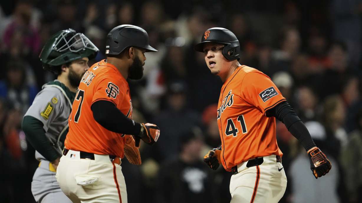 San Francisco Giants' Wilmer Flores, right, celebrates Heliot Ramos after hitting a three-run home run during the sixth inning of a baseball game against the Athletics, Friday, May 16, 2025, in San Francisco.