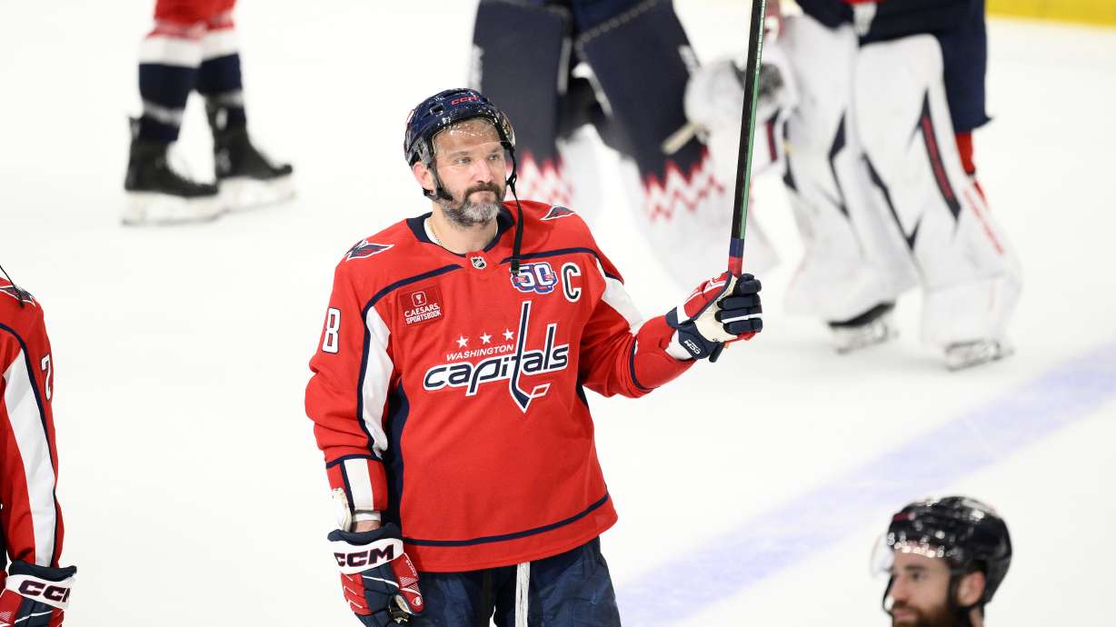 Washington Capitals left wing Alex Ovechkin (8) raises his stick to the crowd after Game 5 of a second-round NHL hockey playoff series against the Carolina HurricanesThursday, May 15, 2025, in Washington.