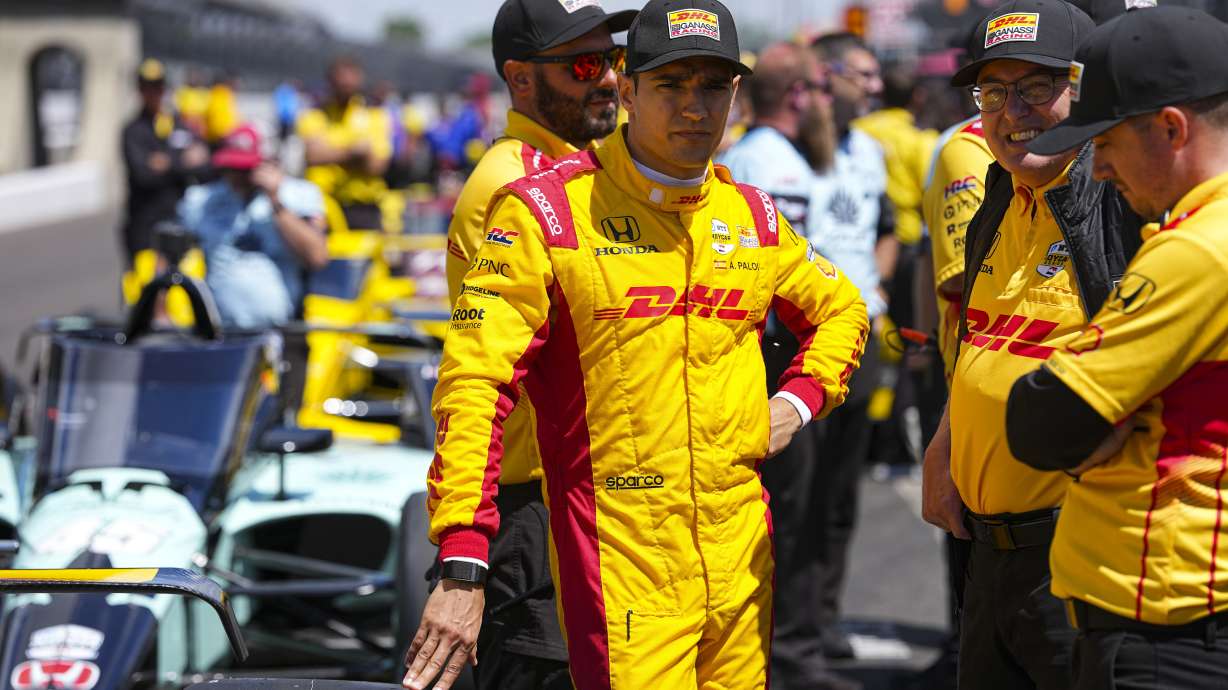 Alex Palou, of Spain, talks with his crew as he waits for is turn during qualification for the Indianapolis 500 auto race at Indianapolis Motor Speedway in Indianapolis, Saturday, May 17, 2025.