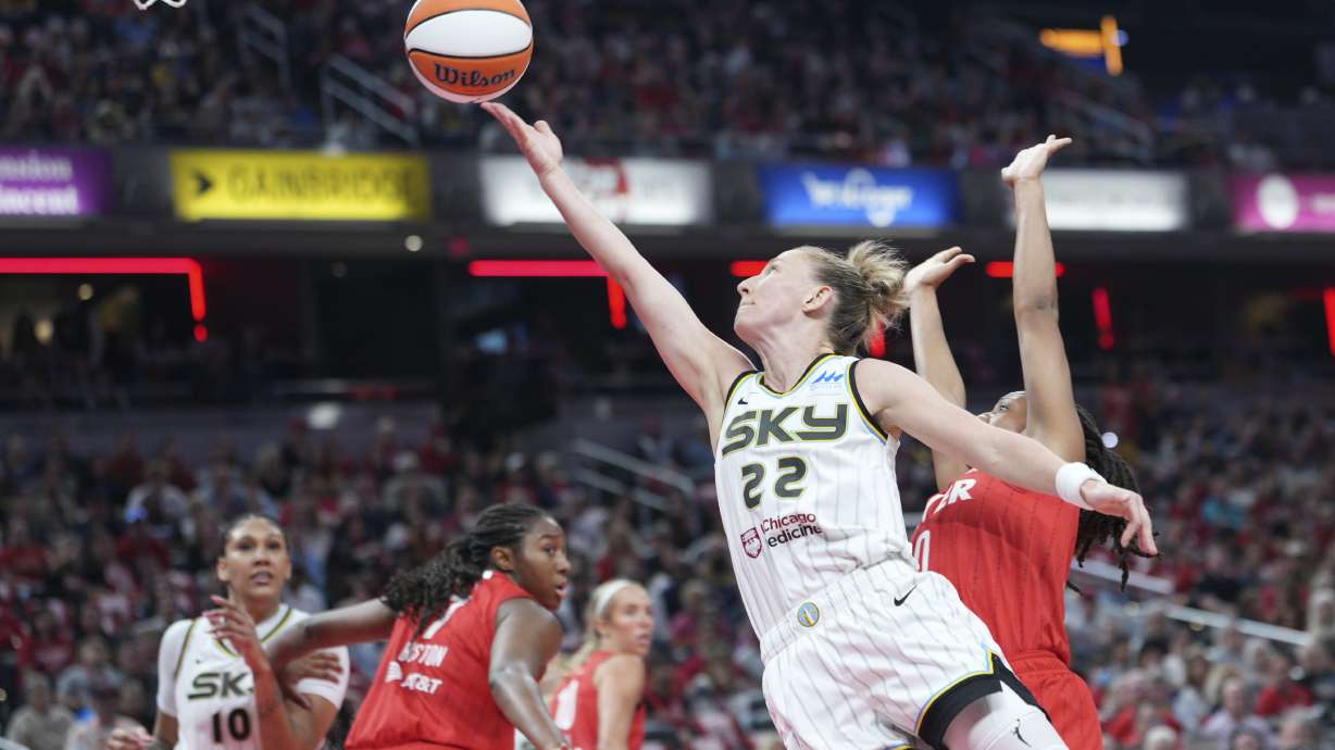 Chicago Sky guard Courtney Vandersloot (22) shoots in front pf Indiana Fever guard Kelsey Mitchell (0) during the first half of a WNBA basketball game in Indianapolis, Saturday, May 17, 2025.