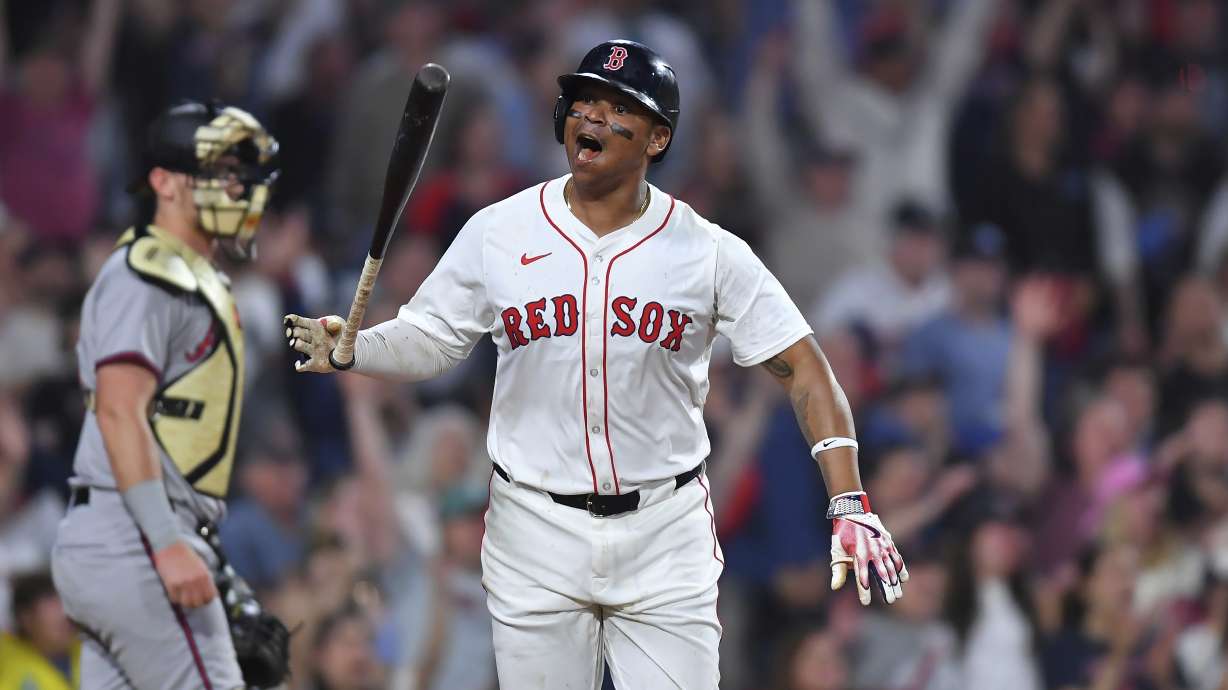 Boston Red Sox's Rafael Devers, right, reacts as he starts to run the bases after hitting a walkoff home run in the ninth inning of a baseball game against the Atlanta Braves, Saturday, May 17, 2025, in Boston.