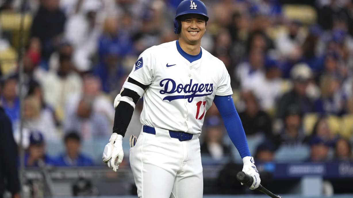 Los Angeles Dodgers' Shohei Ohtani smiles toward the Los Angeles Angels dugout before batting during the first inning of a baseball game Friday, May 16, 2025, in Los Angeles.