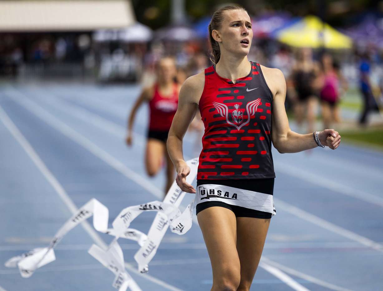 Mountain Ridge’s Kinzlee Riddle crosses the finish line in first place in the 6A girls 400m dash during the 6A state track and field championship at the Clarence F. Robison Outdoor Track & Field at BYU in Provo on Saturday, May 17, 2025.