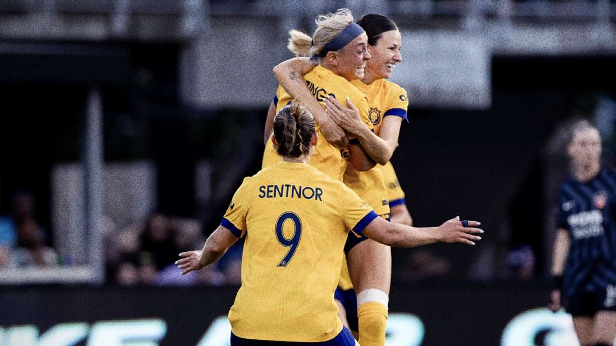 The Utah Royals celebrate a goal by Brecken Mozingo, upper middle.