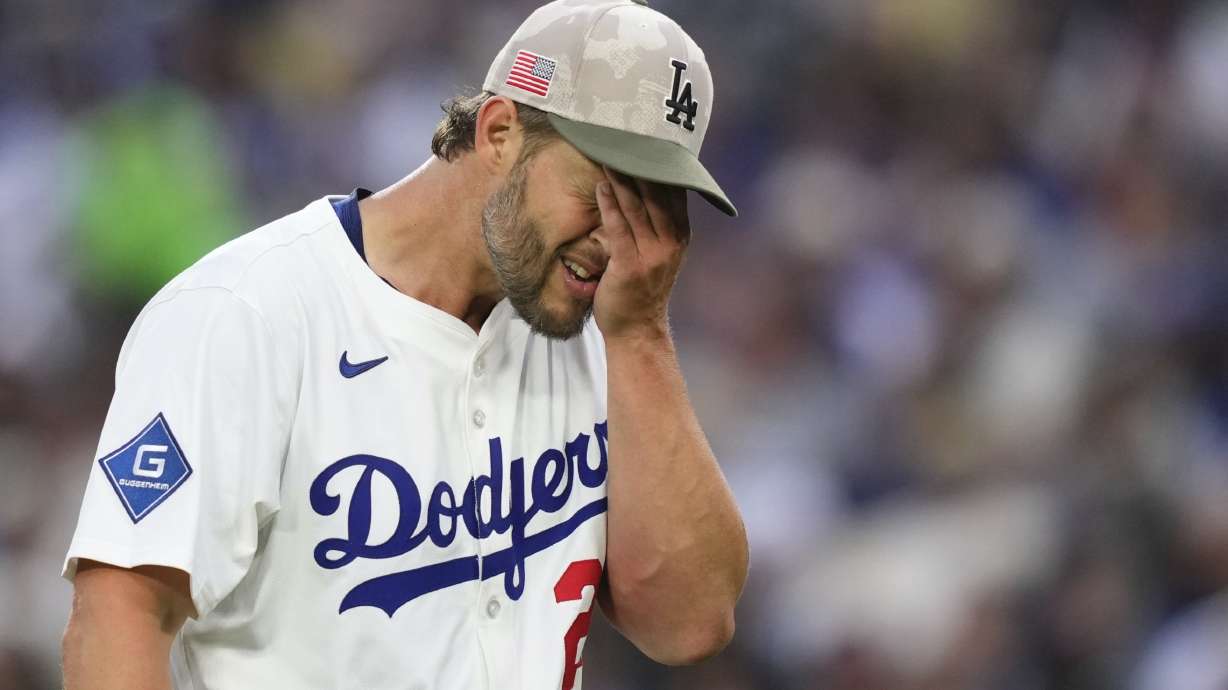 Los Angeles Dodgers starting pitcher Clayton Kershaw wipes his face after the top of the third inning of a baseball game against the Los Angeles Angels, Saturday, May 17, 2025, in Los Angeles.