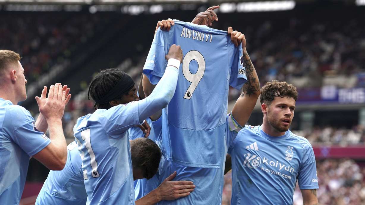 Nottingham Forest's Morgan Gibbs-White celebrates scoring their side's first goal of the game, holding a tribute to teammate Taiwo Awoniyi, during the English Premier League soccer match between Nottingham Forest and West Ham at London Stadium, London, Sunday, May 18, 2025.